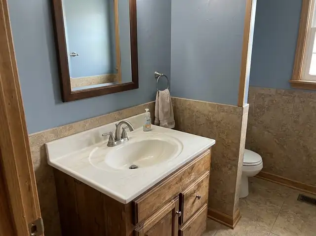 Illustration of a cultured marble vanity top with an integrated sink in a small bathroom
